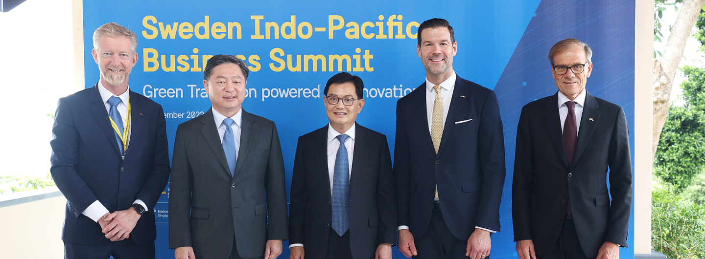 Five people in suits stand before a "Sweden Indo-Pacific Business Summit" banner.